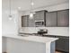Close-up of kitchen featuring gray cabinets, stainless steel appliances and white countertops at 9160 Anthem Ave, Plainfield, IN 46168