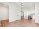 Open floor plan features light wood floors, white walls, and a modern kitchen in the background at 9160 Anthem Ave, Plainfield, IN 46168