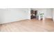 Spacious living area with light wood floors and modern kitchen with stainless appliances in background at 9160 Anthem Ave, Plainfield, IN 46168