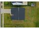 An aerial view displays a home's dark roof, short driveway, lush yard with sidewalk and street bordering its property at 9829 Hulton Rd, Pendleton, IN 46064