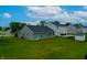 An expansive backyard featuring a well-maintained lawn and a gray house with sliding glass doors to the yard at 9829 Hulton Rd, Pendleton, IN 46064