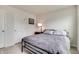 Bedroom with neutral paint, comfortable bed, side table with lamp, and white doors at 9829 Hulton Rd, Pendleton, IN 46064
