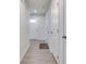 Inviting hallway with wood-look floors and white doors, leading to a bright entryway at 9829 Hulton Rd, Pendleton, IN 46064