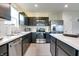 Modern kitchen featuring stainless steel appliances, dark cabinets, and marble countertops at 9829 Hulton Rd, Pendleton, IN 46064