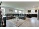 Spacious living room with a plush reclining sofa, open kitchen, and lots of natural light at 9829 Hulton Rd, Pendleton, IN 46064