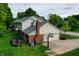 Aerial view of the home features a spacious backyard, attached garage, and brick chimney at 1004 Nevelle Ln, Carmel, IN 46032