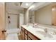 Bathroom with double sinks, tile floors, and a bathtub with shower at 1004 Nevelle Ln, Carmel, IN 46032