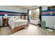 Bedroom featuring a bed, a wooden dresser, and large windows for natural light at 1004 Nevelle Ln, Carmel, IN 46032
