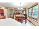 Dining area with a large table, chandelier, and a view into the adjacent living room at 1004 Nevelle Ln, Carmel, IN 46032