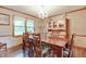 Elegant dining room with a wooden table set for a meal, chandelier, and a large window at 1004 Nevelle Ln, Carmel, IN 46032