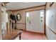 Inviting entryway with wood trim, a classic mirror, and a bright front door with sidelights at 1004 Nevelle Ln, Carmel, IN 46032