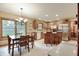 Open kitchen and dining area featuring wood cabinets, stainless appliances, and a sunlit breakfast nook at 1004 Nevelle Ln, Carmel, IN 46032