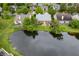 An aerial view of a house with a backyard that backs onto a serene pond, creating a peaceful waterfront property at 11040 Brave Ct, Indianapolis, IN 46236