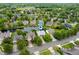 Aerial view of home in a neighborhood featuring mature trees, a lake, and green spaces at 11040 Brave Ct, Indianapolis, IN 46236