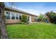 Well-maintained backyard featuring patio furniture, a swing set, and a spacious lawn area at 11040 Brave Ct, Indianapolis, IN 46236