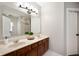 Bathroom with double sinks, granite countertops, wooden cabinets, and neutral color scheme at 11040 Brave Ct, Indianapolis, IN 46236