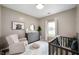 Bright bedroom with accent chair, dresser, decorative mirror, plush carpet, and natural lighting at 11040 Brave Ct, Indianapolis, IN 46236