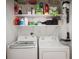 Laundry room with washer, dryer, storage shelves, and cleaning supplies at 11040 Brave Ct, Indianapolis, IN 46236