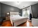 Spacious main bedroom with hardwood floors, ample natural light, and a luxurious upholstered bed at 11040 Brave Ct, Indianapolis, IN 46236