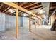 Unfinished basement with exposed beams and concrete foundation walls provides ample storage space at 11575 Freeport Dr, Carmel, IN 46032