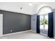 Vaulted primary bedroom features a large window and a combination of blue and gray painted walls at 11575 Freeport Dr, Carmel, IN 46032
