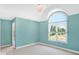 Light-filled bedroom with a large arched window and neutral decor at 11575 Freeport Dr, Carmel, IN 46032