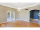 Formal dining area featuring hardwood floors, an elegant chandelier, and arched doorways at 11575 Freeport Dr, Carmel, IN 46032