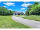Long driveway up to traditional-style home surrounded by lush trees and landscaping at 11575 Freeport Dr, Carmel, IN 46032