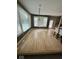 Sunlit living room featuring hardwood floors and large windows with backyard views at 11575 Freeport Dr, Carmel, IN 46032