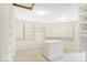 Spacious walk-in closet featuring built-in shelves and a central island for storage at 11575 Freeport Dr, Carmel, IN 46032