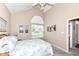 Comfortable bedroom features a vaulted ceiling and a sun-filled window view at 11692 Seven Oaks Dr, Fishers, IN 46038