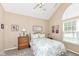 Cozy bedroom with vaulted ceiling, and a large window providing natural light at 11692 Seven Oaks Dr, Fishers, IN 46038
