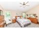 Comfortable bedroom featuring vaulted ceilings, a ceiling fan, and two windows for natural light at 11692 Seven Oaks Dr, Fishers, IN 46038