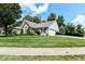 Beautiful home showcasing a well-maintained lawn, mature trees and attached garage at 11692 Seven Oaks Dr, Fishers, IN 46038
