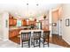 Spacious kitchen features stainless steel appliances, an island with bar seating and modern lighting at 11692 Seven Oaks Dr, Fishers, IN 46038