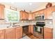 Updated kitchen with stainless steel appliances, tile backsplash and wood cabinets at 11692 Seven Oaks Dr, Fishers, IN 46038