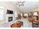 Open concept living room with fireplace, vaulted ceiling, and plenty of natural light at 11692 Seven Oaks Dr, Fishers, IN 46038