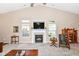 Bright living room with fireplace, vaulted ceiling, and large windows at 11692 Seven Oaks Dr, Fishers, IN 46038