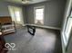 Spacious bedroom features neutral walls, multiple windows, and neutral carpeting at 1304 Franklin St, Columbus, IN 47201