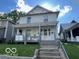 Charming two-story home with a covered porch and updated landscaping in a serene neighborhood at 1304 Franklin St, Columbus, IN 47201