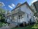Classic two-story home featuring a covered porch, neutral siding, and inviting curb appeal at 1304 Franklin St, Columbus, IN 47201