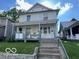 Charming two-story home with a covered porch and updated landscaping in a serene neighborhood at 1304 Franklin St, Columbus, IN 47201