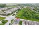 Aerial view of the neighborhood showcasing the community park, streets, and school in the distance at 13048 Minden Dr, Fishers, IN 46037