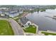 Stunning aerial view of lakeside community clubhouse with beach, fire pit and manicured green space for relaxing outdoors at 13048 Minden Dr, Fishers, IN 46037