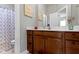 Bathroom with a wooden vanity, a white countertop, and a shower with a patterned curtain at 13048 Minden Dr, Fishers, IN 46037
