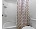 Clean bathroom featuring a white tiled shower and tub with a decorative shower curtain at 13048 Minden Dr, Fishers, IN 46037