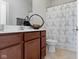 Cozy bathroom featuring a modern vanity, stylish mirror, and shower-tub combination with geometric curtain at 13048 Minden Dr, Fishers, IN 46037