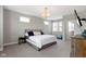 Comfortable bedroom with large windows, neutral walls, and bedside table at 13048 Minden Dr, Fishers, IN 46037