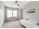Cozy bedroom with a ceiling fan, a cityscape painting, and a comfortable bed near bright windows at 13048 Minden Dr, Fishers, IN 46037