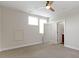 Light-filled bedroom showcasing neutral walls, trim, carpet and a ceiling fan with an attached bathroom at 13048 Minden Dr, Fishers, IN 46037